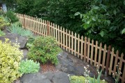 Picket fence along rock wall